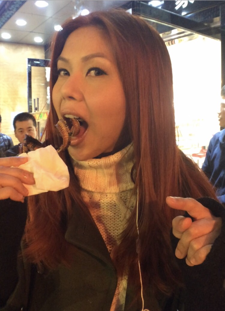 Bianca Valerio eating snake Wangfujing Snack Street